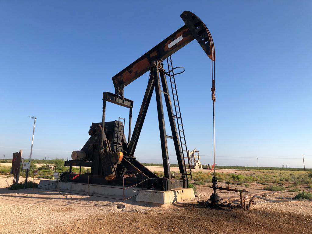 Producing pumping unit and wellhead equipment at a West Texas location